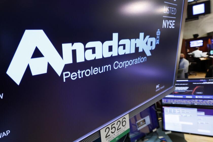 FILE - In this April 12, 2019, file photo the logo for Anadarko Petroleum Corp. appears above a trading post on the floor of the New York Stock Exchange. Warren Buffets Berkshire Hathaway is financing a bid by Occidental Petroleum for Anadarko, potentially upending Chevrons $33 billion offer for the energy company. Anadarko and Chevron signed a merger agreement earlier this month, but Anadarko Petroleum said Monday, April 29, that it is now considering an offer from Occidental worth about $57 billion in cash and stock. (AP Photo/Richard Drew, File)