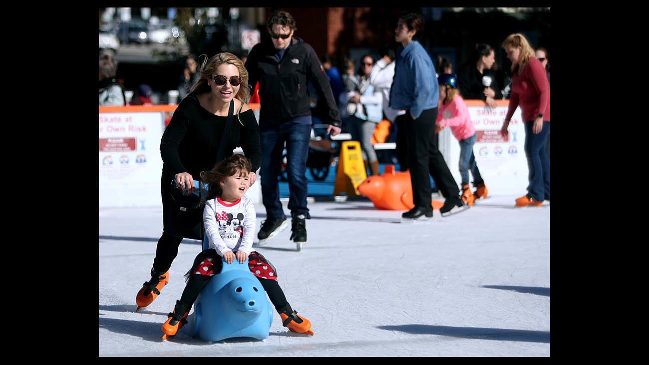 Carolina Flores of North Hollywood and her daughter Kaya, 3, smiles as they skate around the Ice America ice skating rink behind city hall on Third St. in Burbank on Thursday, Dec. 27, 2018. The 4,100 square-foot rink, which holds 165 skaters at a time, will remain open until Jan. 6, 2019.