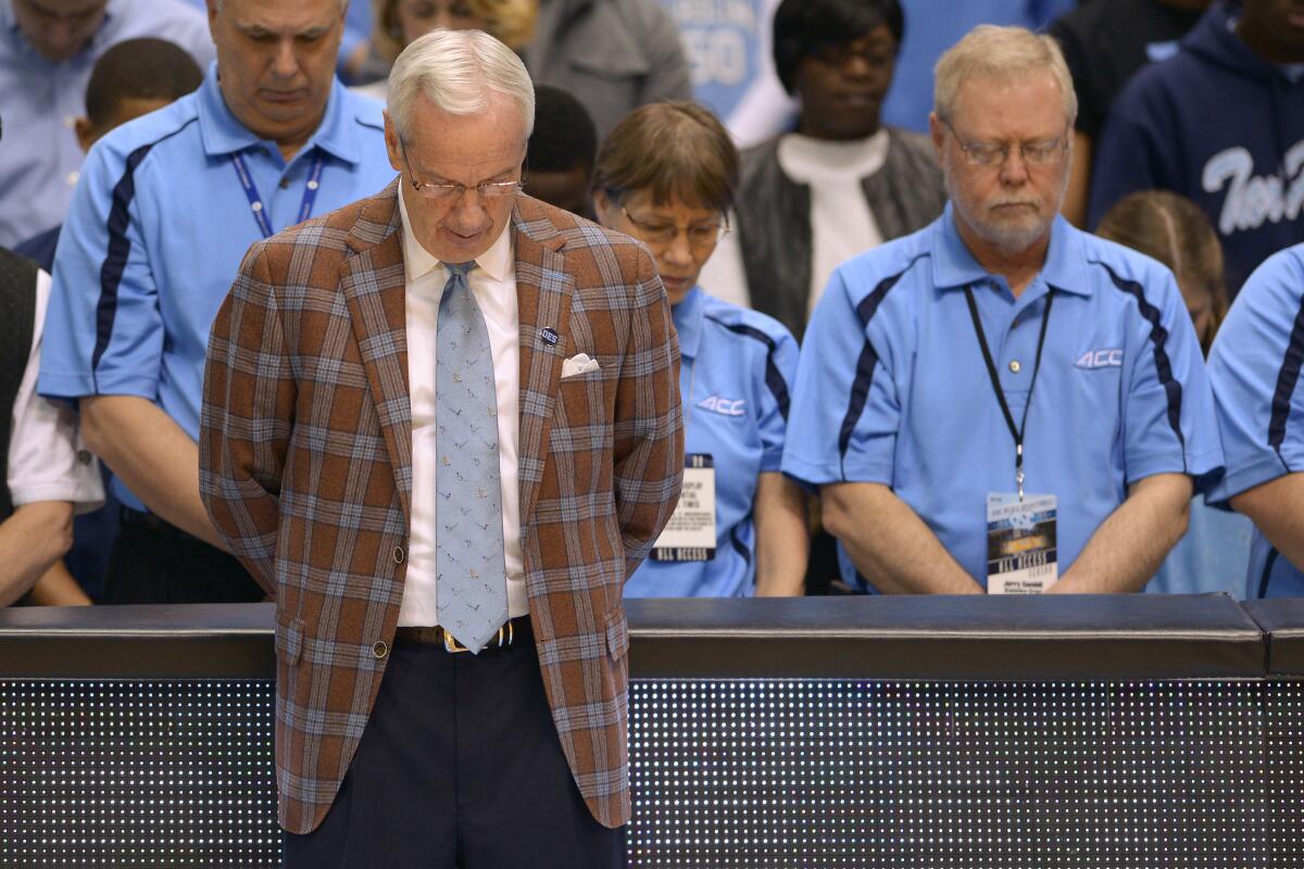 North Carolina Coach Roy Williams bows during a moment of silence before a game against Georgia Tech on Feb. 21, 2015.