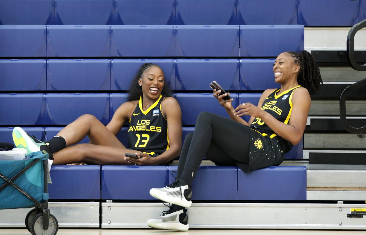 Sisters Chiney, left, and Nneka Ogwumike share a laugh while sitting in the bleachers at El Camino College.