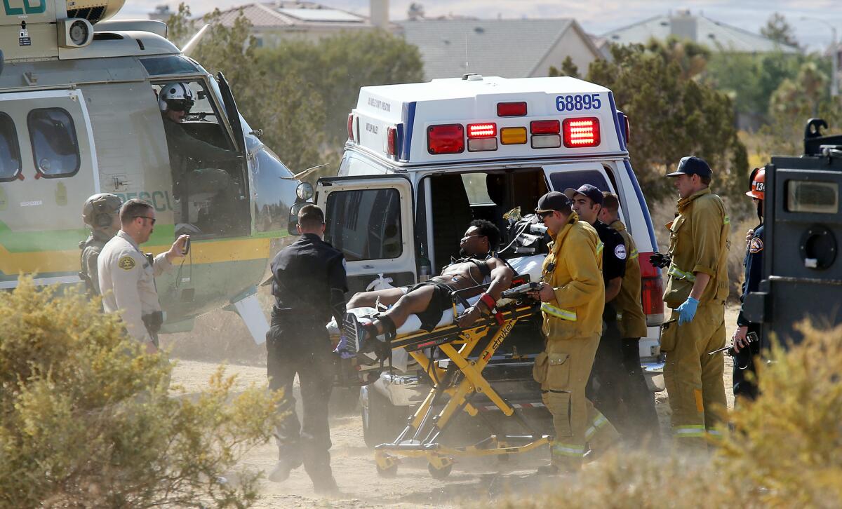 Law enforcement and Fire Department personnel transport the shooting suspect in Lancaster.