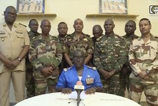 FILE - In this image taken from video provided by ORTN, Col. Maj. Amadou Abdramane, front center, makes a statement on July 26, 2023, in Niamey, Niger, as a delegation of military officers appeared on Niger State TV to read out a series of communiques announcing their coup d'etat. The U.S. is scrambling to assess the future of its counterterrorism operations in the Sahel region of Africa after the ruling junta in Niger announced it was ending military cooperation with Washington. (ORTN via AP, File)