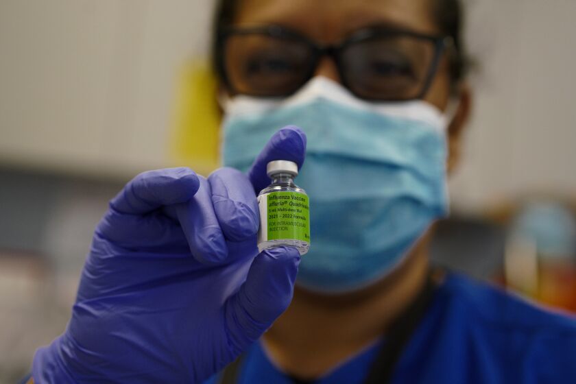 On Friday, Oct. 29, 2021 at the San Diego County Public Health office in Chula Vista, CA., Carmen Gomez, LVN with the county prepared the flu inoculation for her next patient. (Nelvin C. Cepeda / The San Diego Union-Tribune)