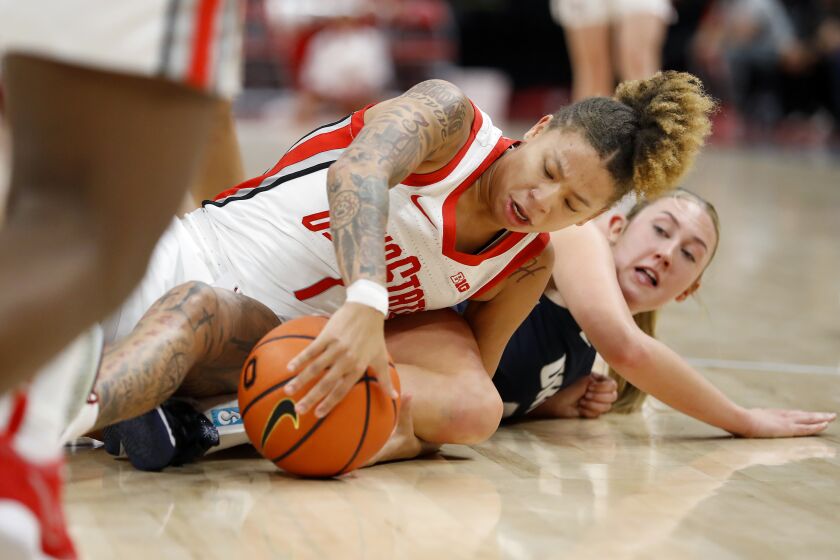 Ohio State guard Rikki Harris (1) dives for the loose ball with New Hampshire guard Brooke Kane, right, during the first half of an NCAA college basketball game in Columbus, Ohio, Thursday, Dec. 8, 2022. (AP Photo/Joe Maiorana)