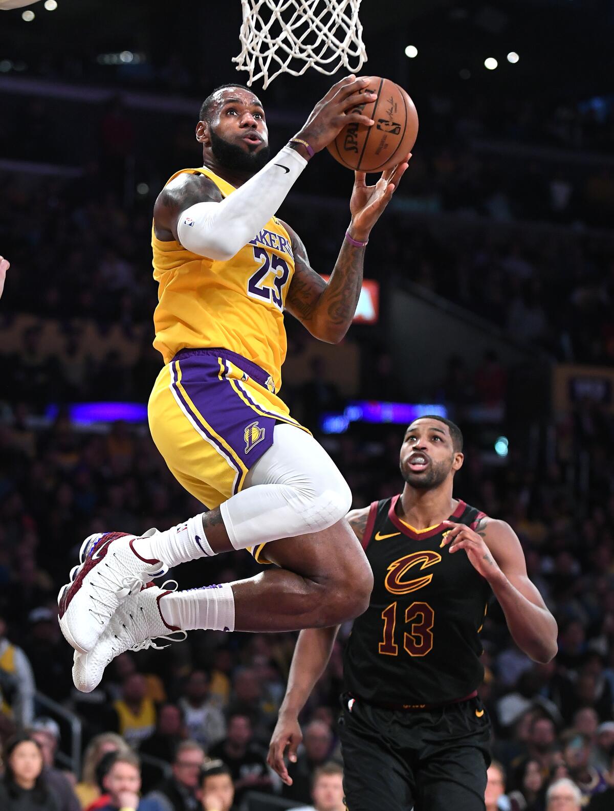 Lakers' LeBron James beats Cleveland Cavaliers' Tristan Thompson to score a basket in the fourth quarter at the Staples Center on Monday.