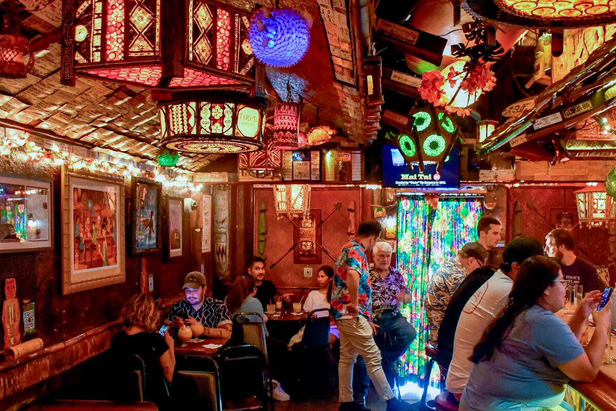 Tiki Ti, a tiny tropical bar on Sunset Boulevard, is filled with tiki decor and patrons in aloha shirts.