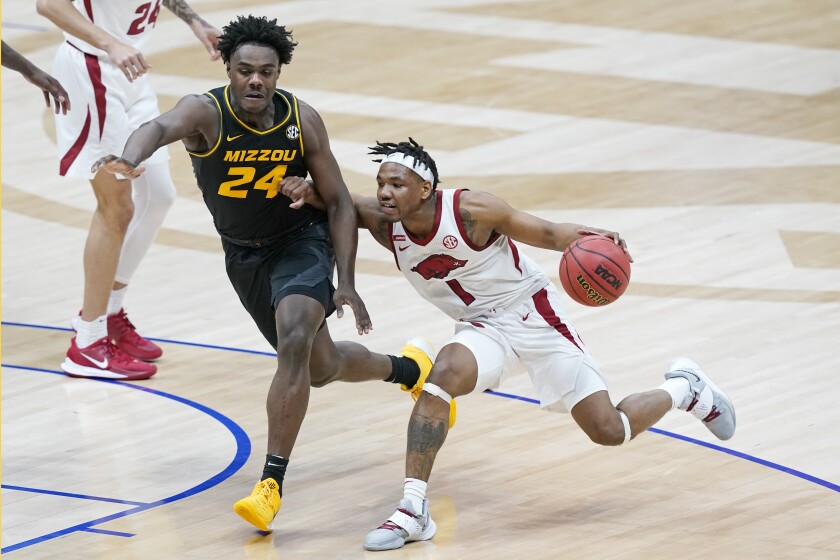 Arkansas' JD Notae (1) drives against Missouri's Kobe Brown (24) in the first half of an NCAA college basketball game in the Southeastern Conference Tournament Friday, March 12, 2021, in Nashville, Tenn. (AP Photo/Mark Humphrey)