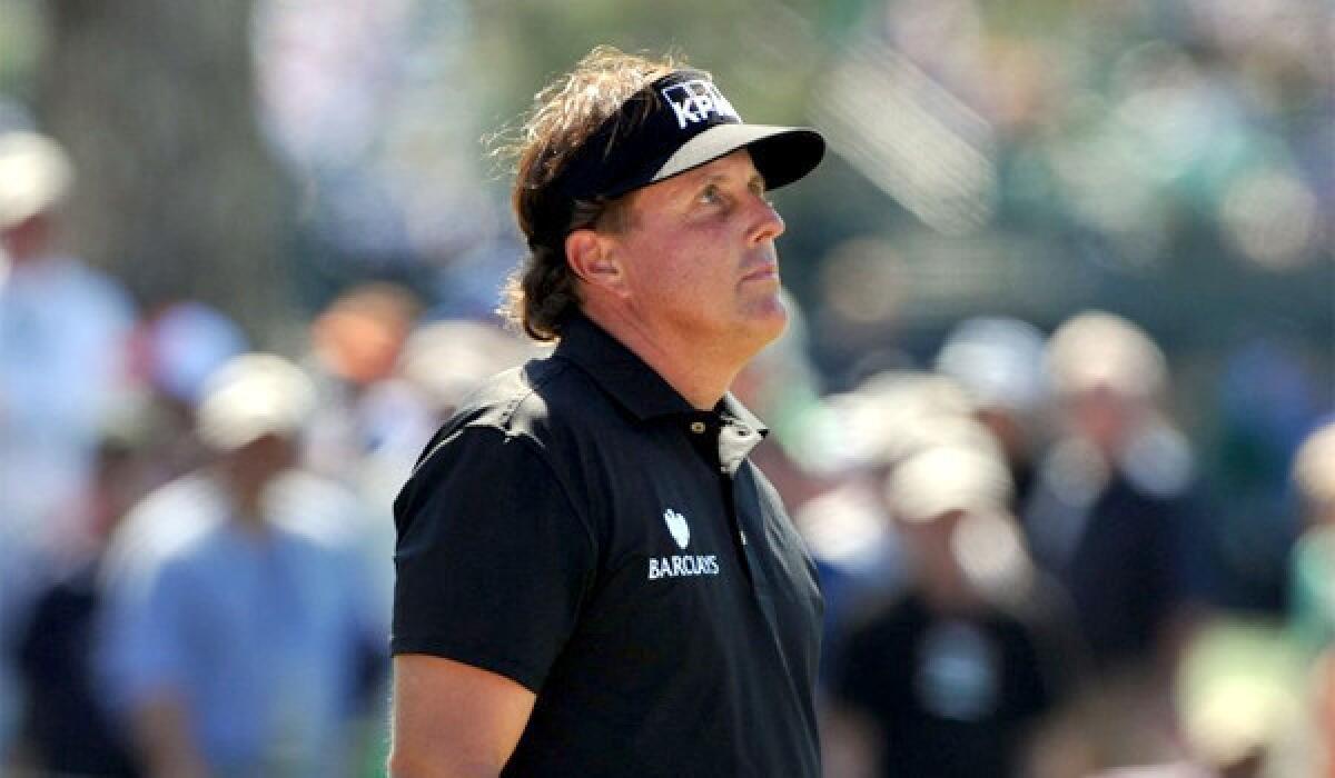 Phil Mickelson reacts to a triple bogey on the 7th hole of the Augusta National Golf Club on Thursday during the first round of the Masters. Mickelson shot a four-over-par 76.