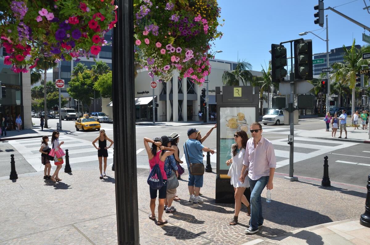 Pedestrians stroll along Rodeo Drive in Beverly Hills.