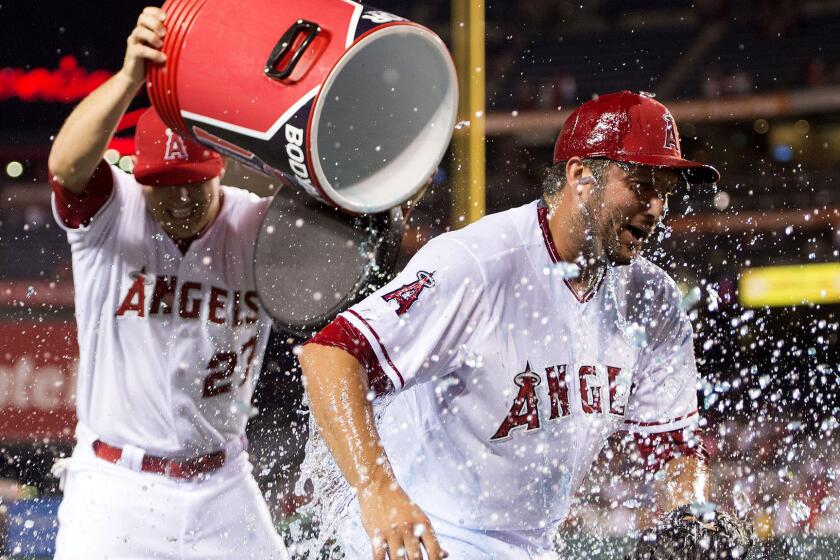 Angels closer Huston Street is doused by teammate Mike Trout after earning the 300th save of his career in a 5-2 victory over the Twins on Wednesday night in Anaheim.