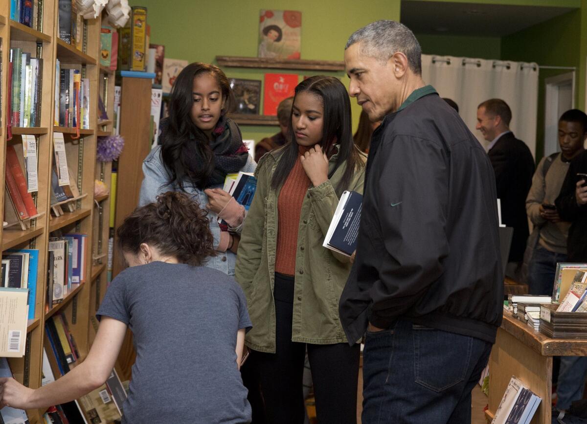 President Obama, right, joined by his daughters Sasha, left, and Malia, center, at Upshur Street Books in Washington, D.C.