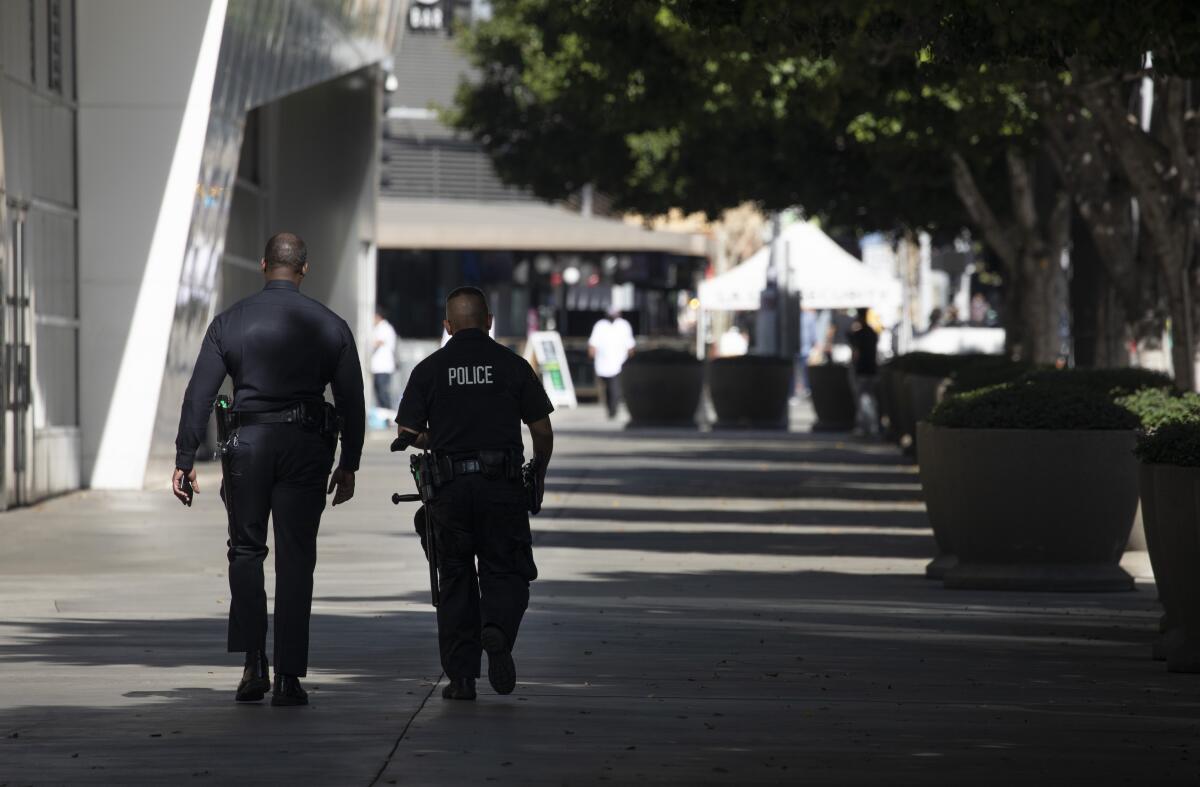Los Angeles Police Department officers walk near the Convention Center