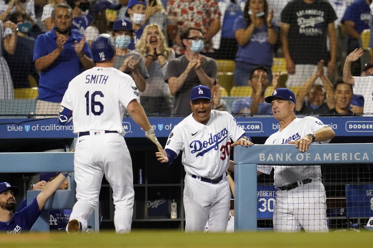 Will Smith, left, is congratulated by Dodgers manager Dave Roberts and bench coach Bob Geren.