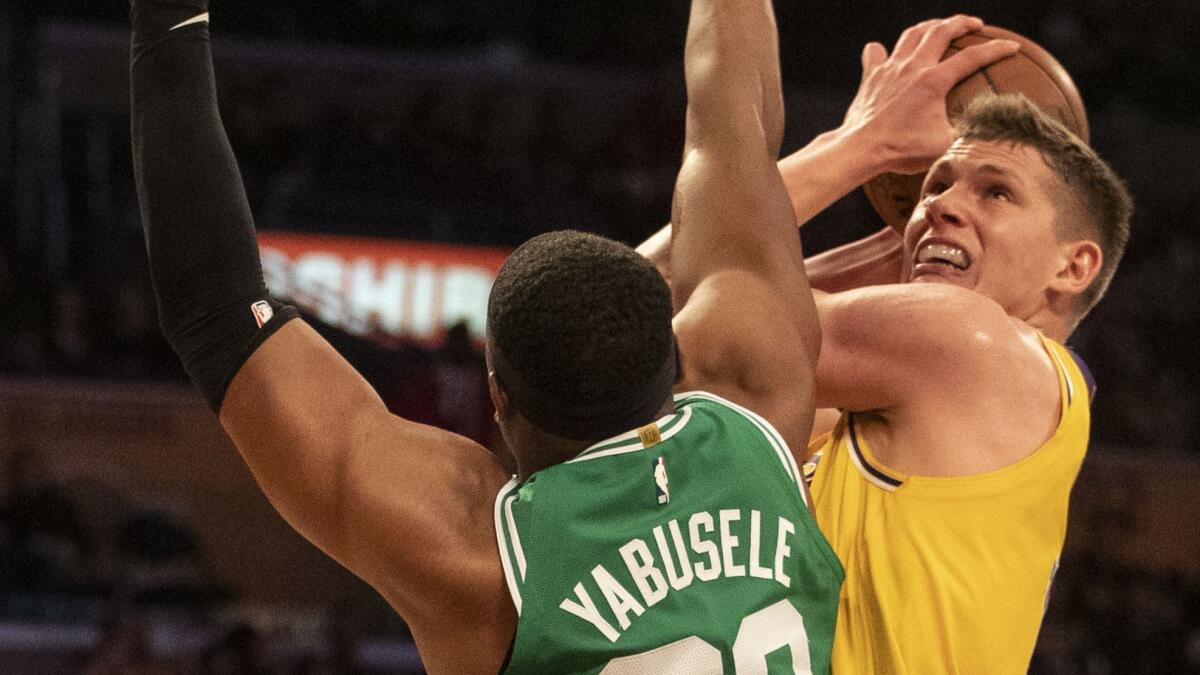 Lakers forward Moe Wagner tries to score over Celtics forward Guerschon Yabusele on Saturday night.