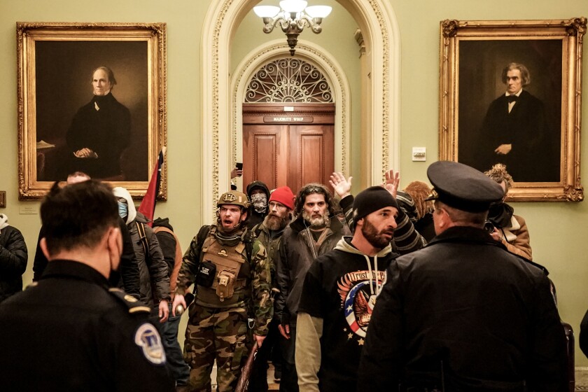 Rioters confront officials at the US Capitol on January 6, 2021.