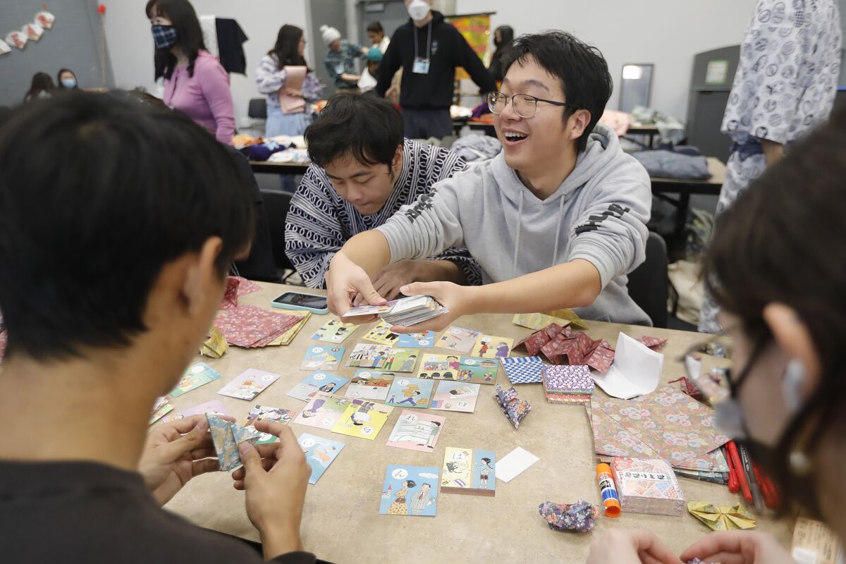 Students play a card game as they celebrate the annual Lunar New Year celebration.