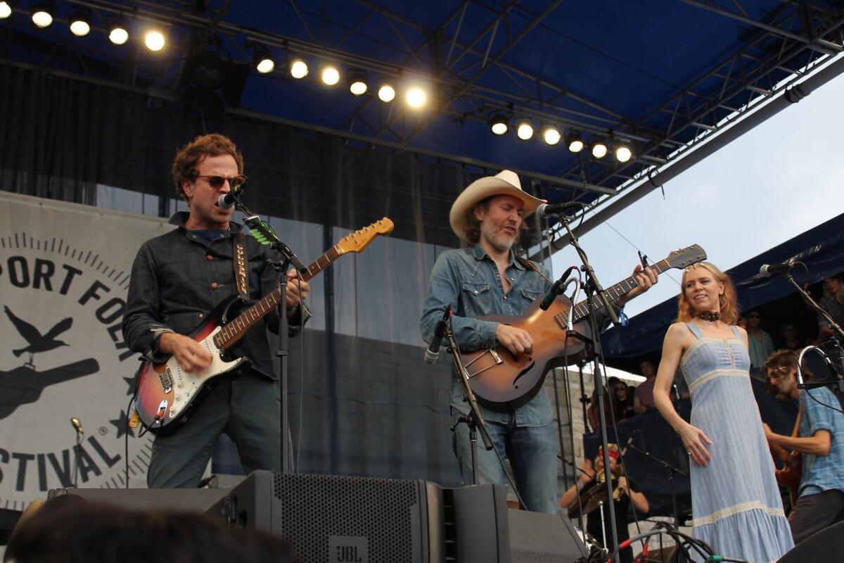 Taylor Goldsmith, left, David Rawlings and Gillian Welch perform during a celebration of the 50th anniversary of Dylan's first electrified performance at the Newport Folk Festival in Newport, R.I. Goldsmith is playing the Fender Stratocaster guitar that Dylan used in his 1965 performance.