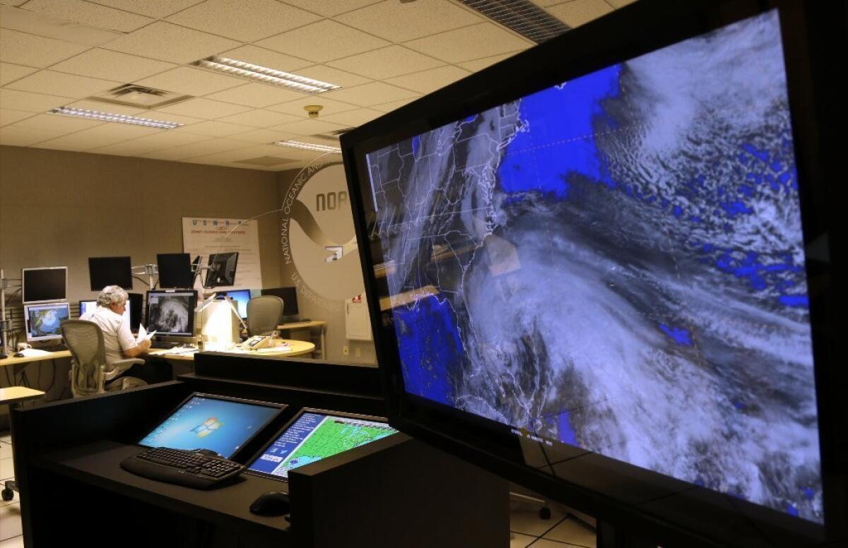 A satellite image of Hurricane Sandy is shown on a computer screen at the National Hurricane Center in Miami. The National Weather Service's website for the Eastern region of the U.S. went offline Tuesday because of a "systems failure."