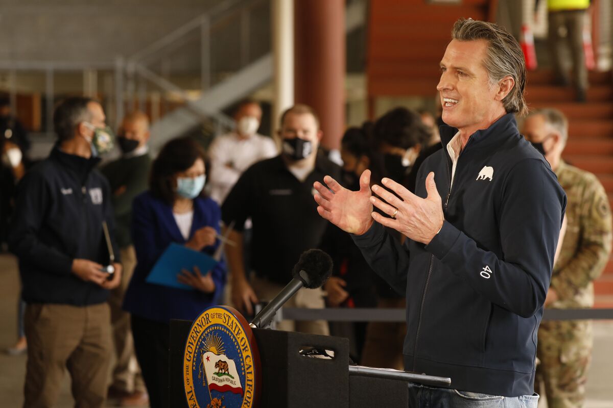 Gov. Gavin Newson addresses a press conference at a COVID-19 vaccination site at Cal State Los Angeles.