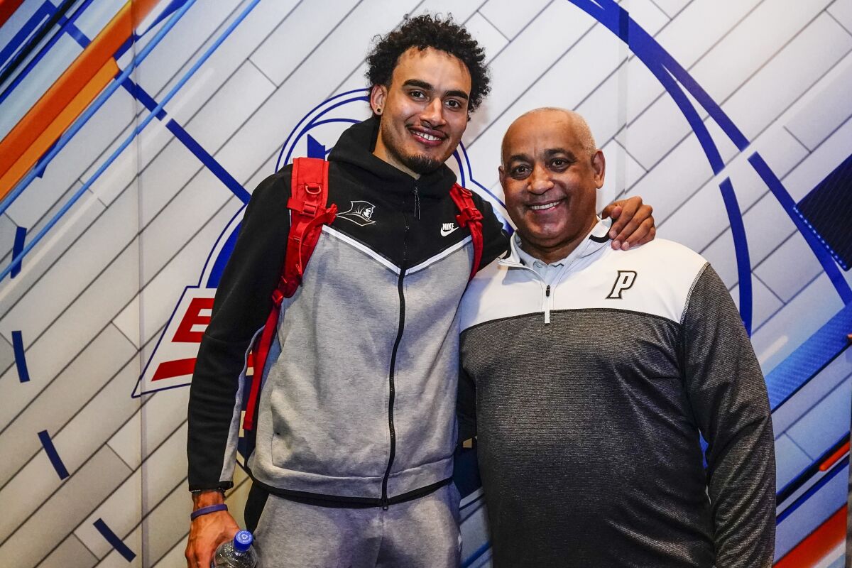 Providence's Justin Minaya, left, poses for a photograph with his father Omar Minaya after an NCAA college basketball game against Butler at the Big East conference basketball tournament Thursday, March 10, 2022, in New York. Providence won 65-61. (AP Photo/Frank Franklin II)