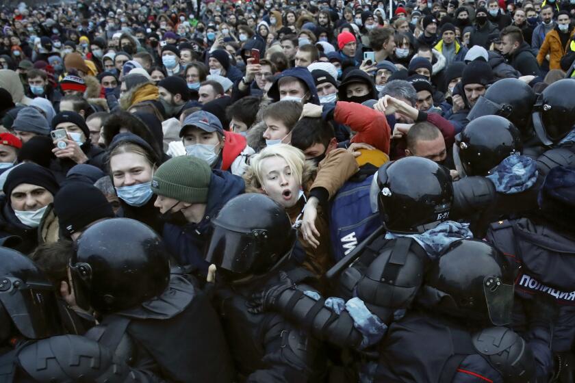 FILE - People clash with police during a protest against the jailing of opposition leader Alexei Navalny in St. Petersburg, Russia, Saturday, Jan. 23, 2021. In pressure unprecedented in post-Soviet Russia, since the imprisonment of Navalny, scores of activists, independent journalists and rights advocates have been targeted with raids, detentions and designations as terrorists and foreign agents. (AP Photo/Dmitri Lovetsky, File)