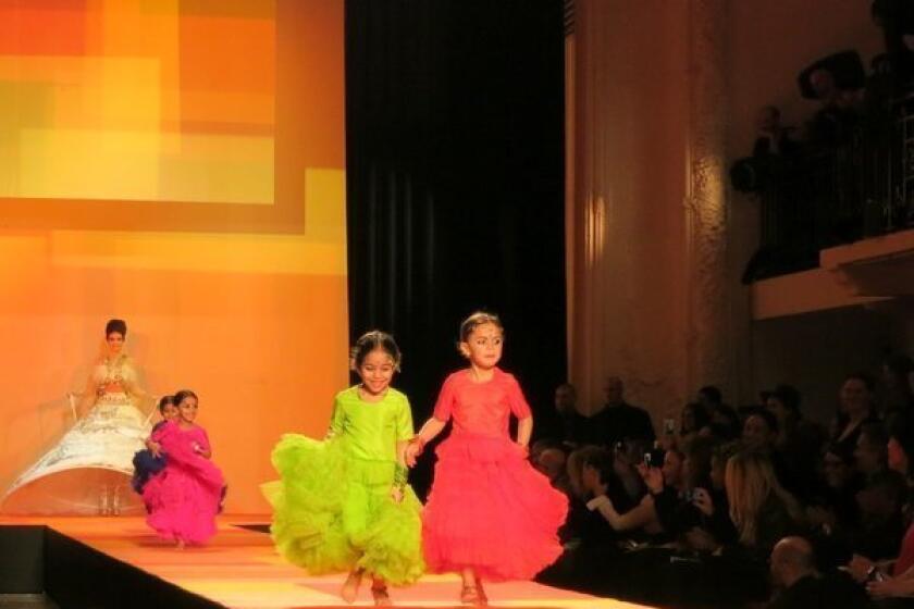 Four colorfully clad children race along Jean Paul Gaultier's runway on Wednesday before a model clad as a bride.