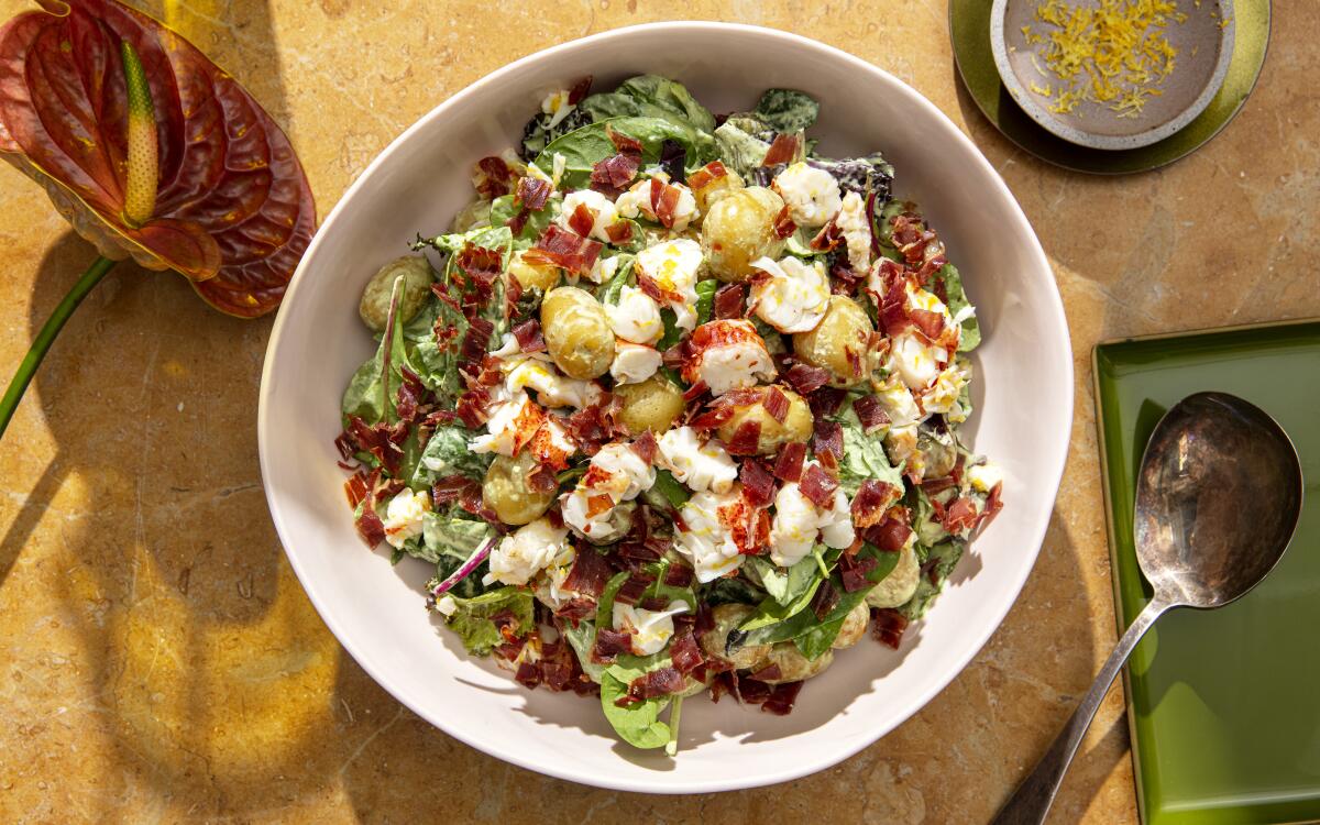 Green goddess dressing dresses this simple potato salad, topped with salty prosciutto and rich, lemony lobster.