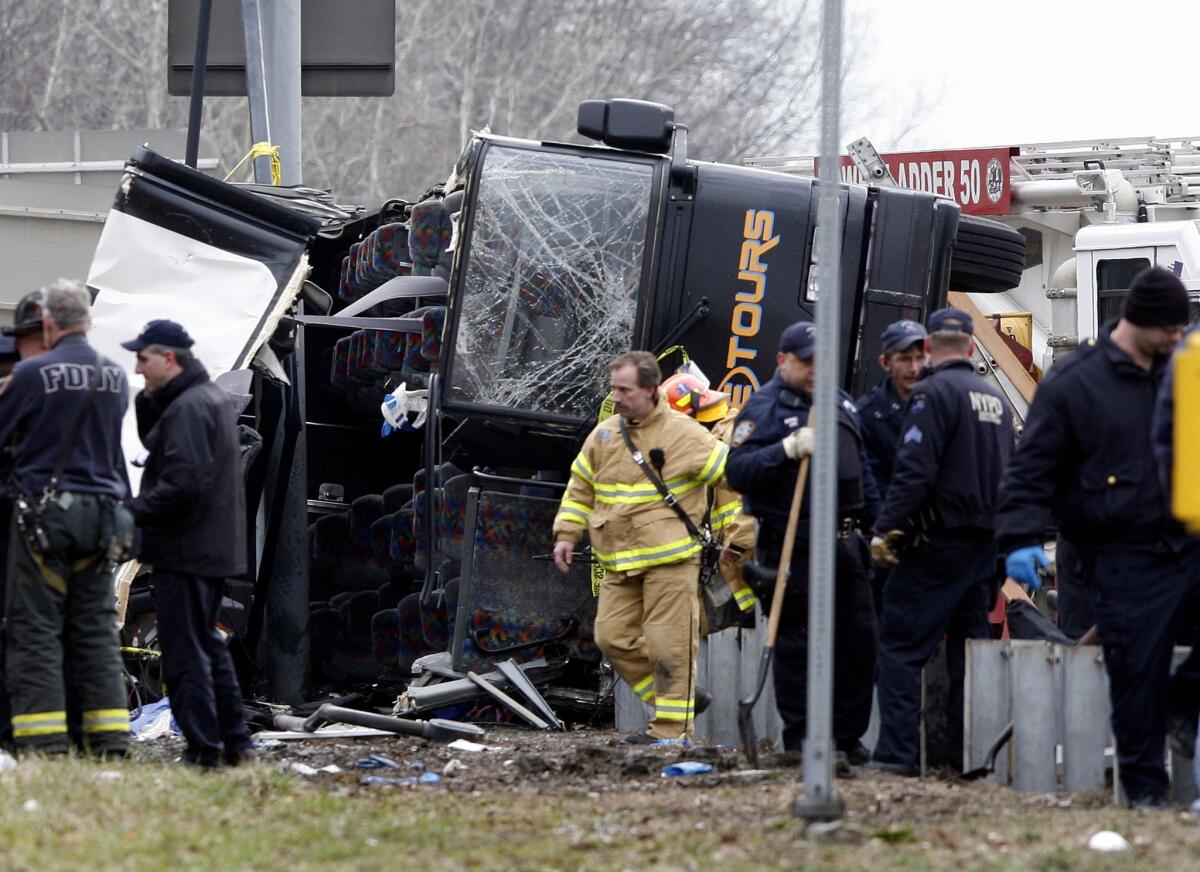 Emergency personnel investigate the scene of a bus crash in the Bronx borough of New York in March 2011.