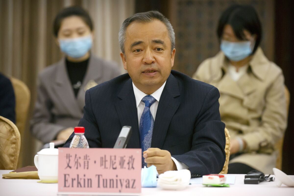 In this April 22, 2021, photo, Erkin Tuniyaz speaks during a press conference in Urumqi in northwestern China's Xinjiang Uyghur Autonomous Region. Erkin Tuniyaz was appointed the acting chairman of the regional government of Northwest China's Xinjiang Uyghur Autonomous Region on Thursday, Sept. 30, 2021, replacing Shohrat Zakir. (AP Photo/Mark Schiefelbein)