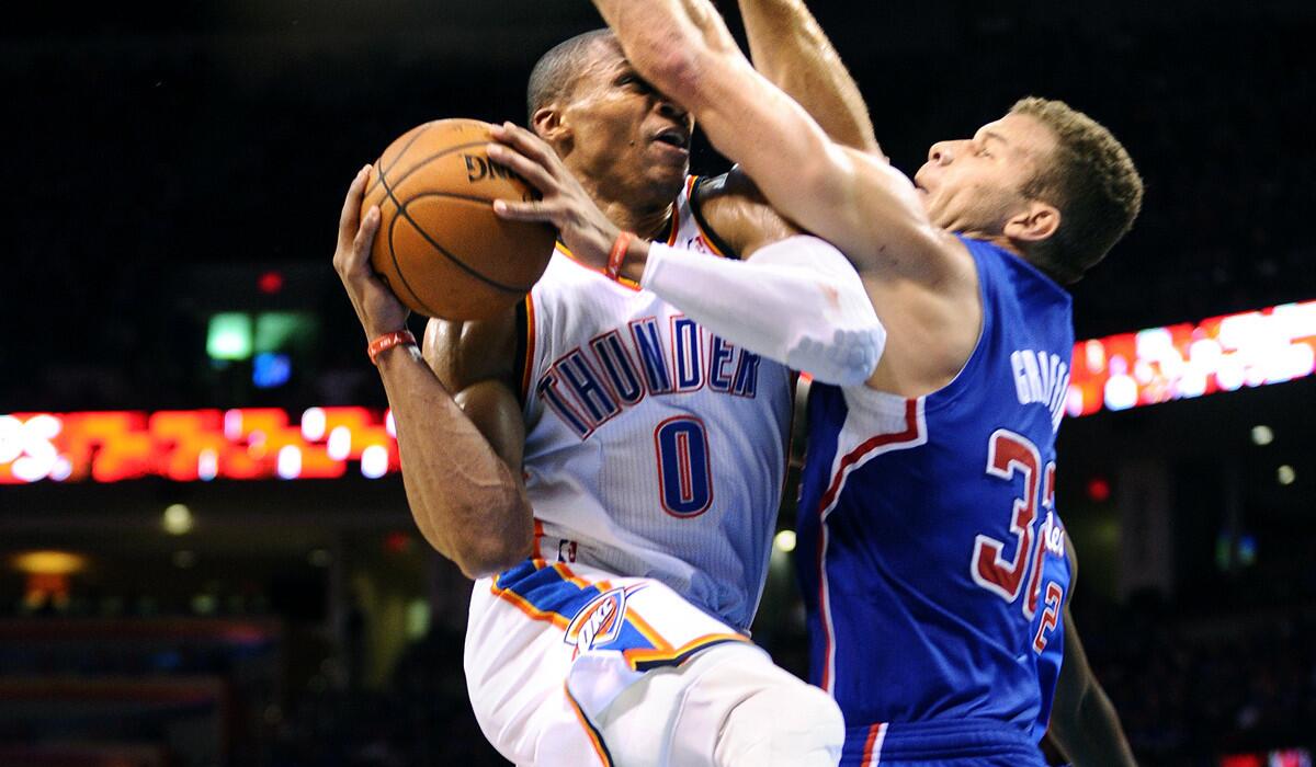 Clippers power forward Blake Griffin fouls Thunder point guard Russell Westbrook on a layup.