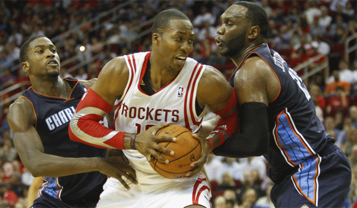 Dwight Howard, shown guarded by Charlottes' Michael Kidd-Gilchrist (14) and Al Jefferson (25), is averaging 15 points and a league-leading 21 rebounds for Houston so far this season.