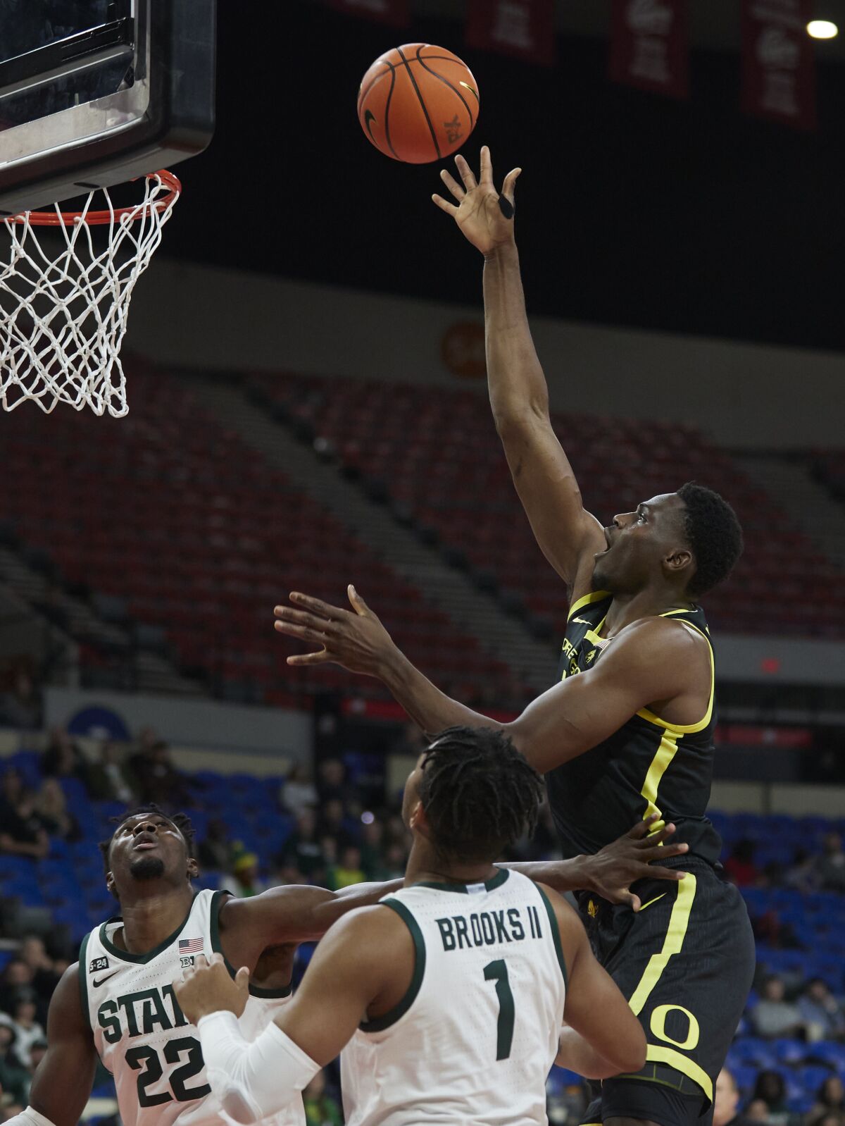 Oregon center N'Faly Dante, right, shoots over Michigan State guard Pierre Brooks (1) and center Mady Sissoko (22) during the first half of an NCAA college basketball game in the Phil Knight Invitational tournament in Portland, Ore., Friday, Nov. 25, 2022. (AP Photo/Craig Mitchelldyer)