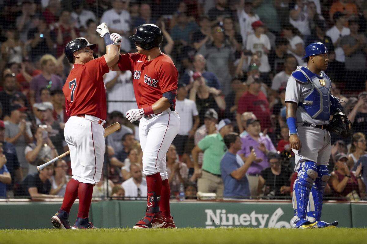 Boston Red Sox's Hunter Renfroe, left, comes in to field the