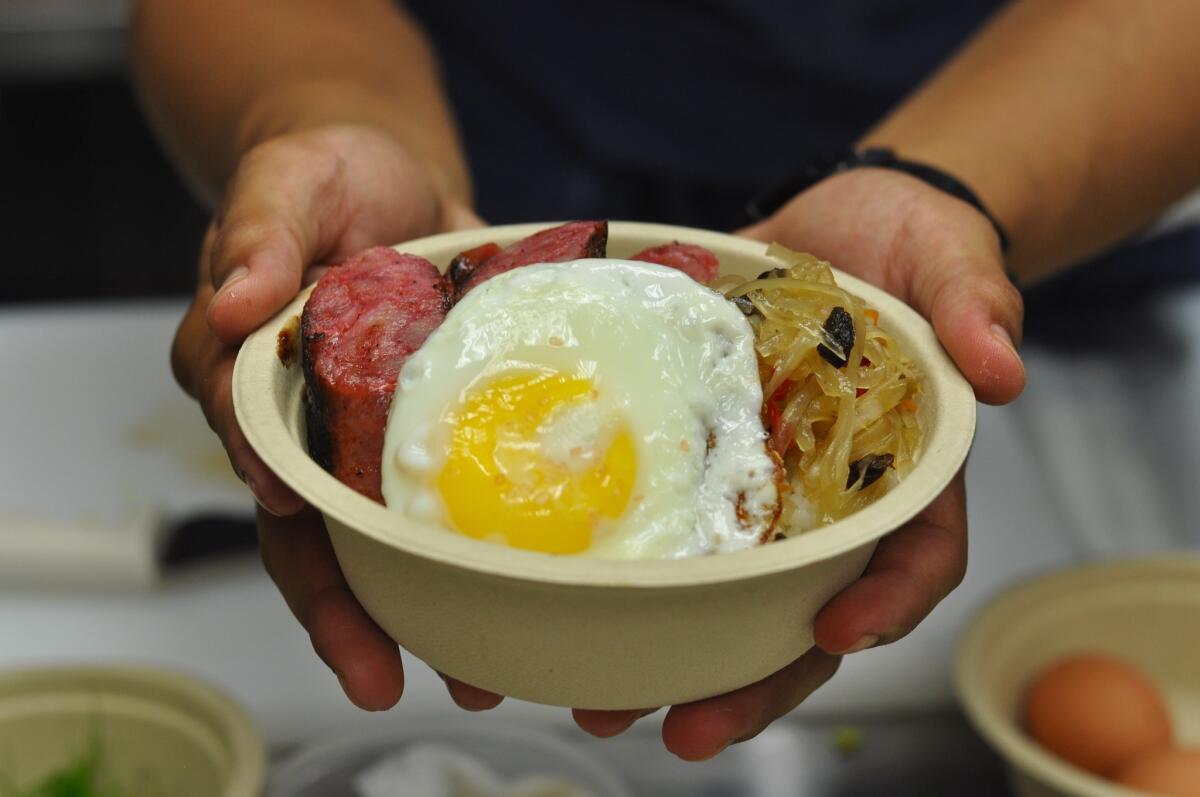 Chef Charles Olalia presents his pork longanisa bowl with fried egg, rice and pickled papaya at Ricebar.