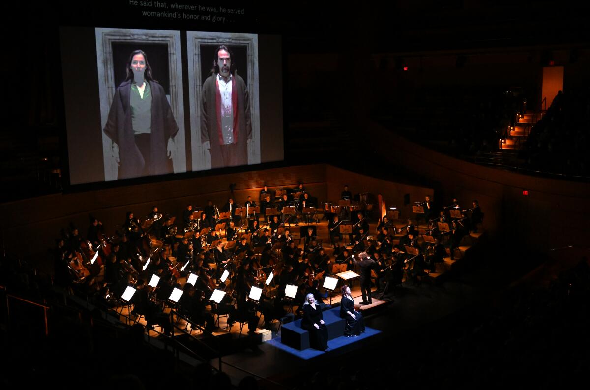An orchestra playing on a large stage.