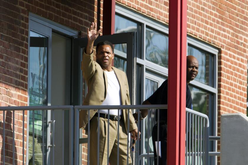 Former U.S. Rep. Jesse Jackson Jr. waves as he leaves a halfway house Monday in Baltimore.