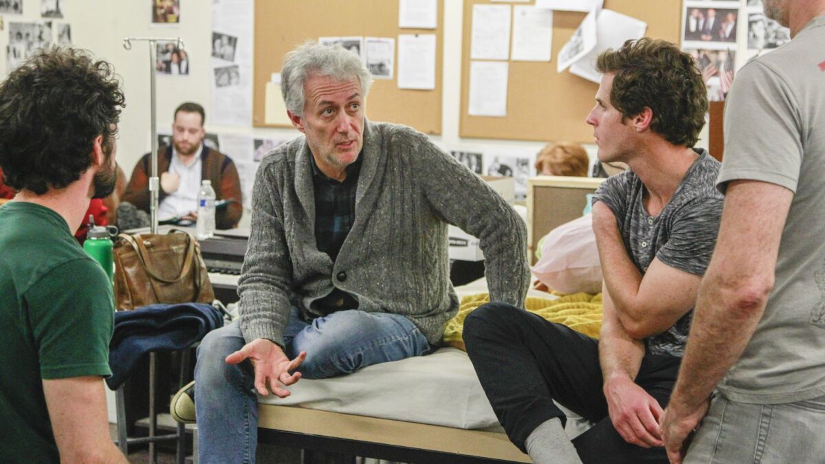 "Angels in America" director and Cygnet Theatre artistic chief Sean Murray talks over a scene with cast and crew.