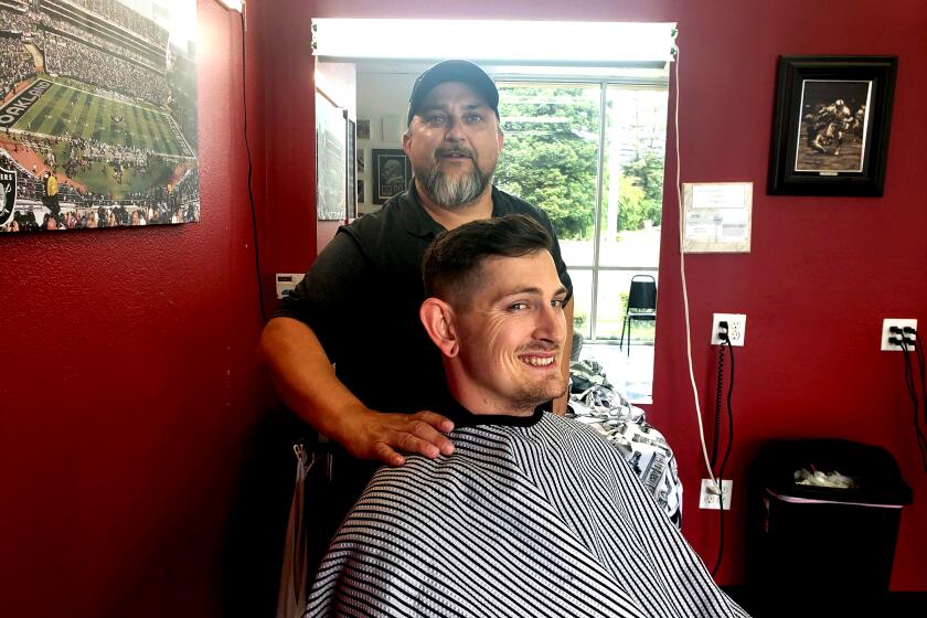 Wes Heryford, 42, owner of the Butte House Barber Shop in Yuba City, with J. Farr, 28, a customer who drove more than 10 hours from Olympia, Washington State for a haircut. Photo courtesy of Wes Heryford