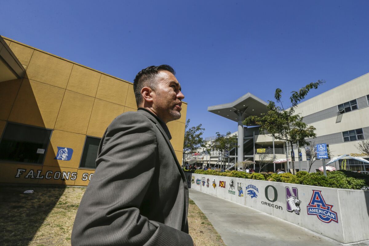 Principal Martin Gomez walks through Santee Education Complex in South L.A.