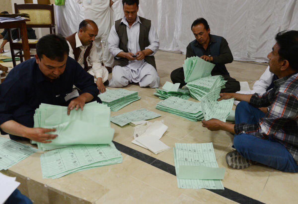 Pakistani election officials count ballot papers.