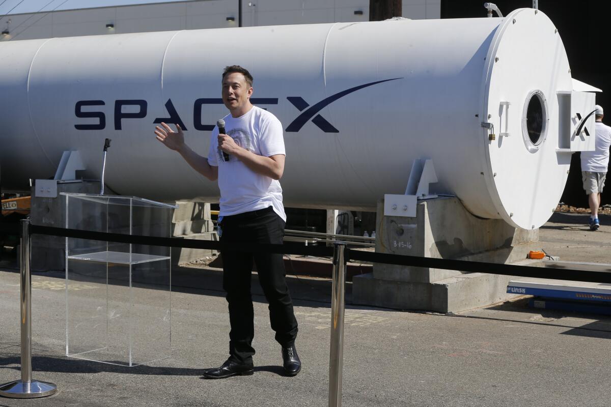 Telsa CEO Elon Musk congratulates the winners of a hyperloop competition at SpaceX's Hyperloop track in Hawthorne, Calif.