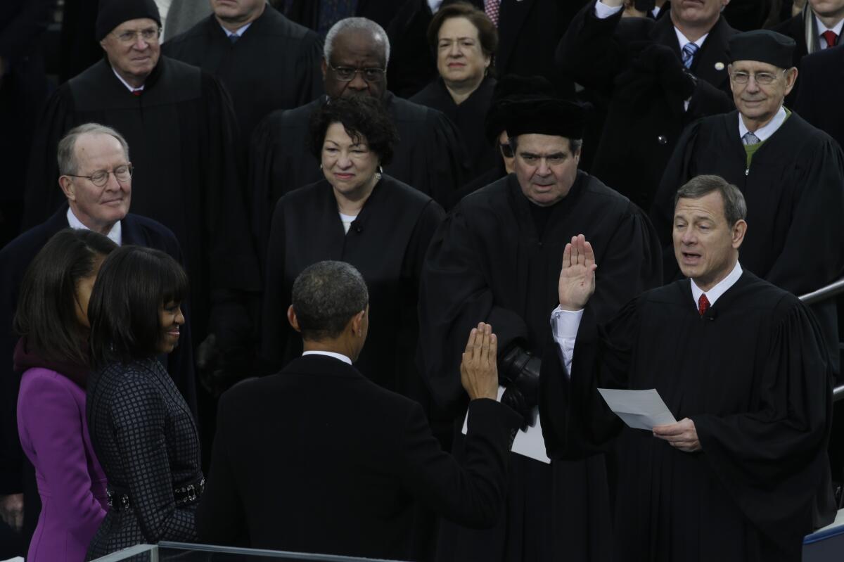 Supreme Court Chief Justice John G. Roberts Jr. reads the oath of office to President Obama in 2013.