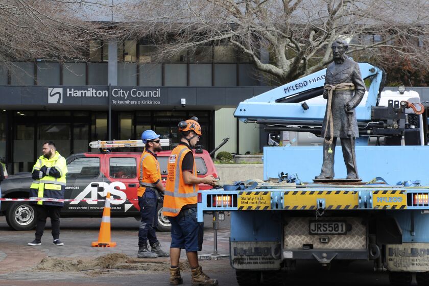 In this image provided by Hamilton City Council, council workers remove the bronze statue of British Captain John Fane Charles Hamilton from a square in central Hamilton, New Zealand, Friday, June 12, 2020. The New Zealand city of Hamilton on Friday removed a bronze statue of the British naval officer the city is named after a man who is accused of killing indigenous Maori people in the 1860s. (Hamilton City Council via AP)