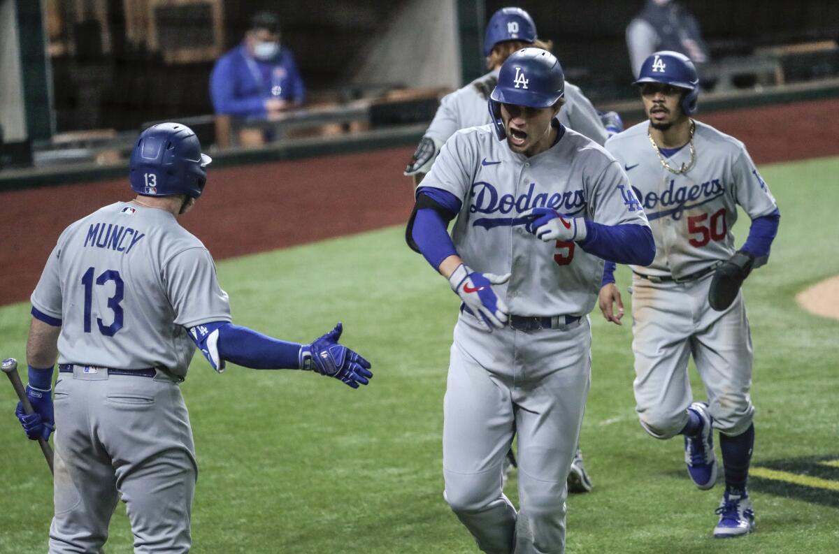 Corey Seager, center, celebrates with teammates after hitting a home run.