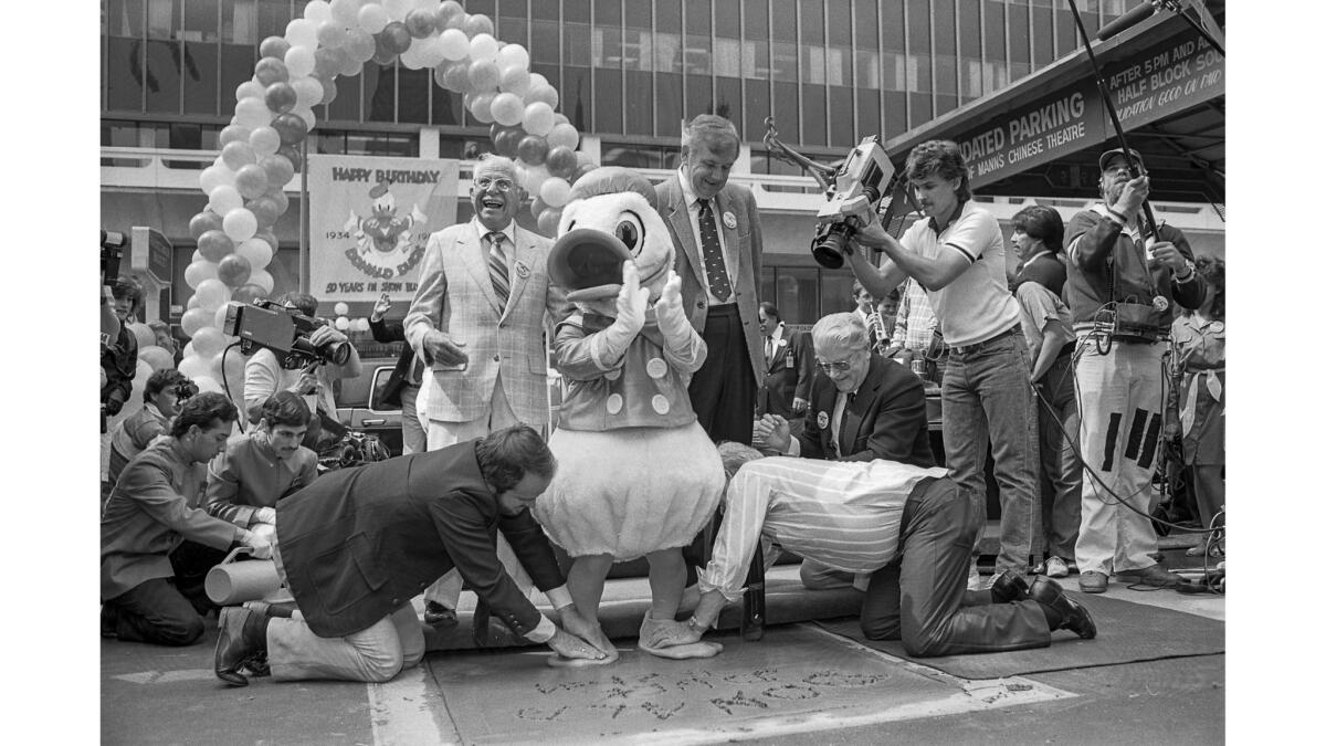 May 21, 1984: Disney's Donald Duck sets his footprints in cement of courtyard at Mann's Chinese Theatre.