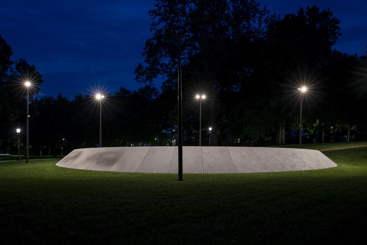 A view of the new Memorial to Enslaved Laborers at night, with the eyes of Isabella Gibbons visible at left. 