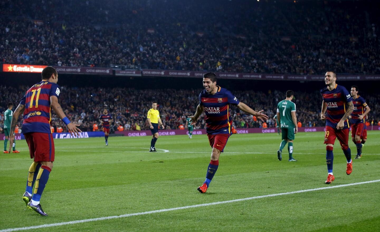 Barcelona's Luis Suarez celebrates his second goal with Neymar against Eibar during their Spanish first division soccer match at Camp Nou stadium in Barcelona