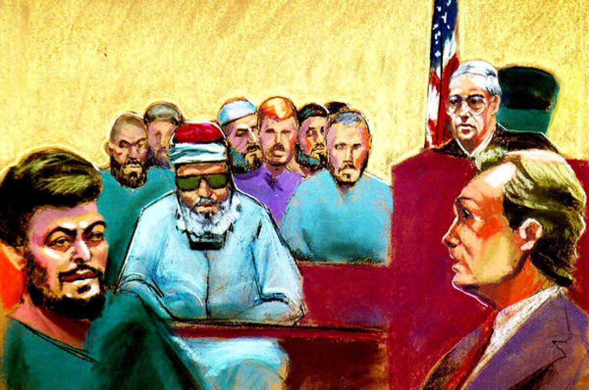 El Sayyid Nosair, left, Sheik Omar Abdel Rahman, center, and 13 codefendants appear at their arraignment in New York in Aug. 26, 1993. They faced charges of conspiring to bomb targets including the World Trade Center and planning assassinations and kidnappings. Judge Michael Mukasey and Assistant U.S. Atty. Matthew Fishbein are at right.