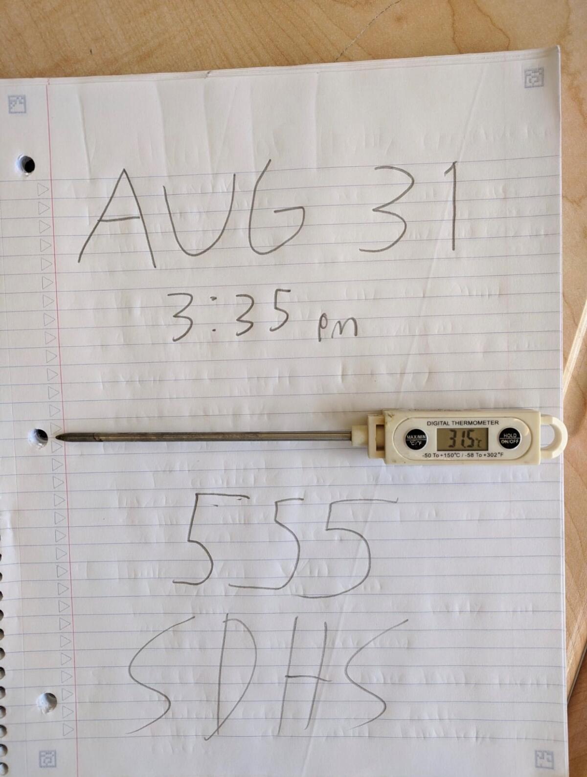A thermometer reading "31.5" sits on a sheet of ruled paper that says "Aug. 31, 3:35 p.m., 555 SDHS"