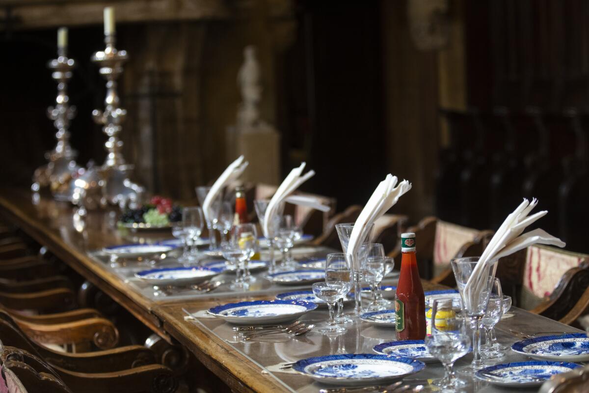 The dining table in the Refectory at Hearst Castle is set with ketchup, mustard and paper napkins just as the owner liked it.